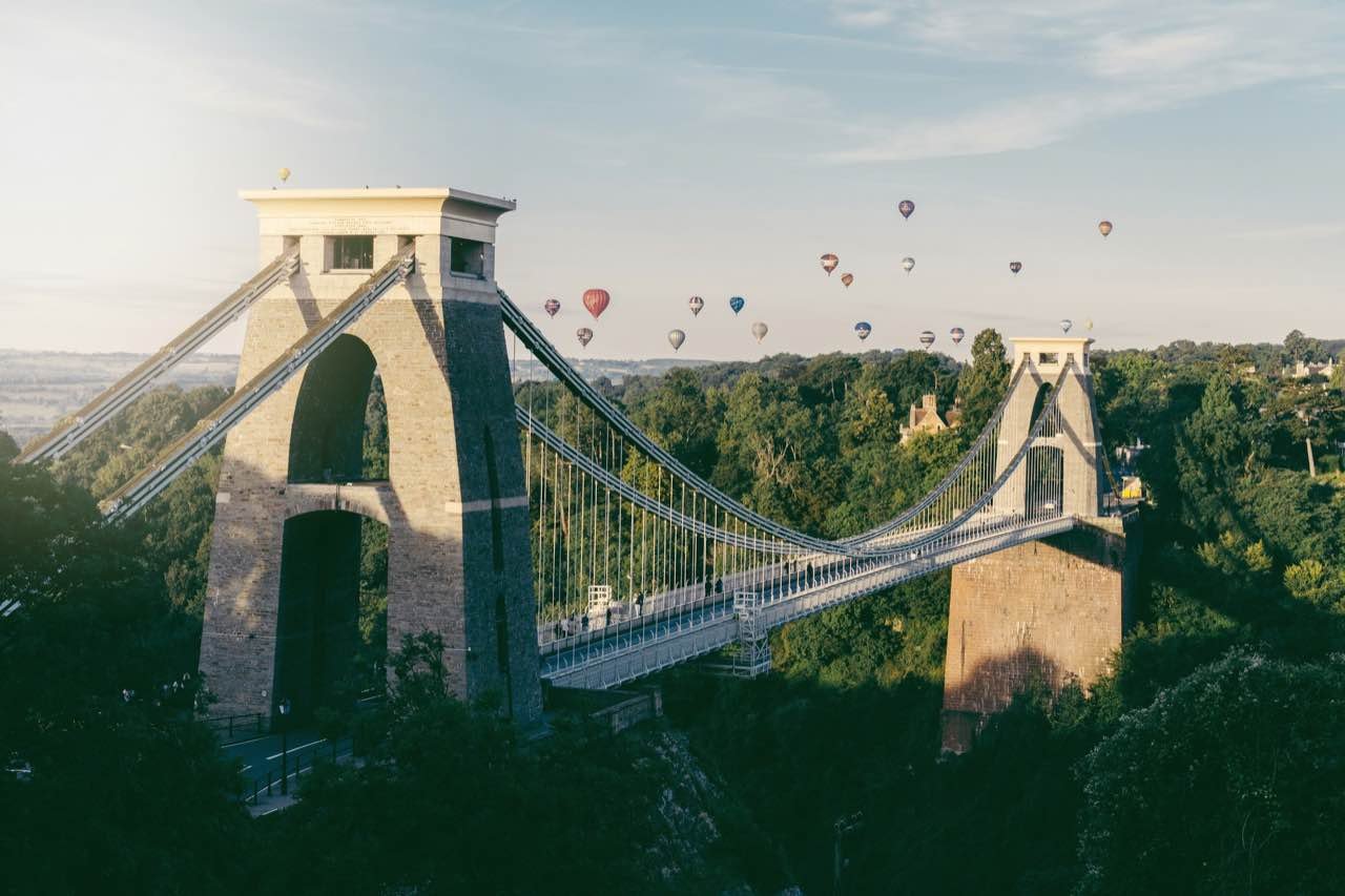 Clifton Suspension Bridge in Bristol, with hot-air balloons in the sky behind
