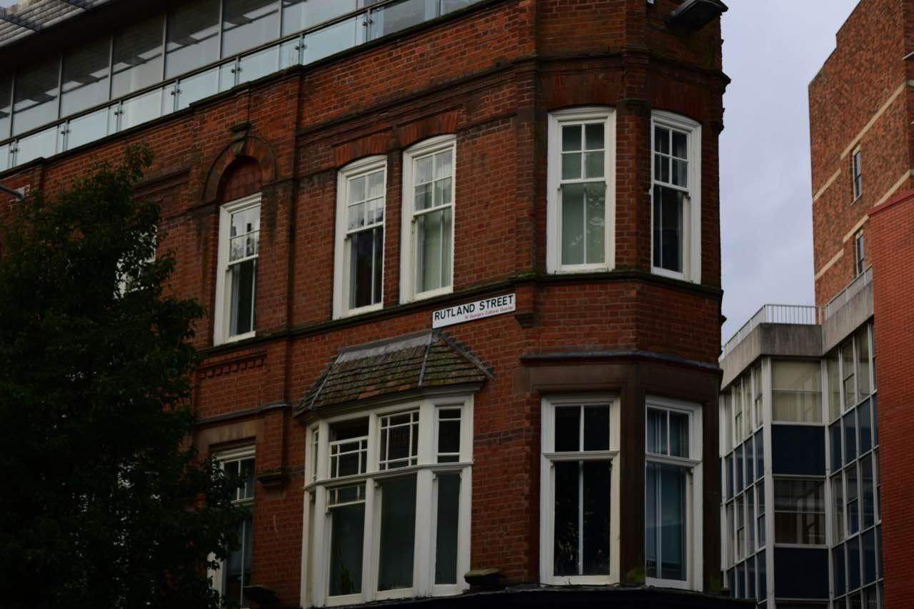 A red-brick corner building with bay windows on Rutland Street in Leicester