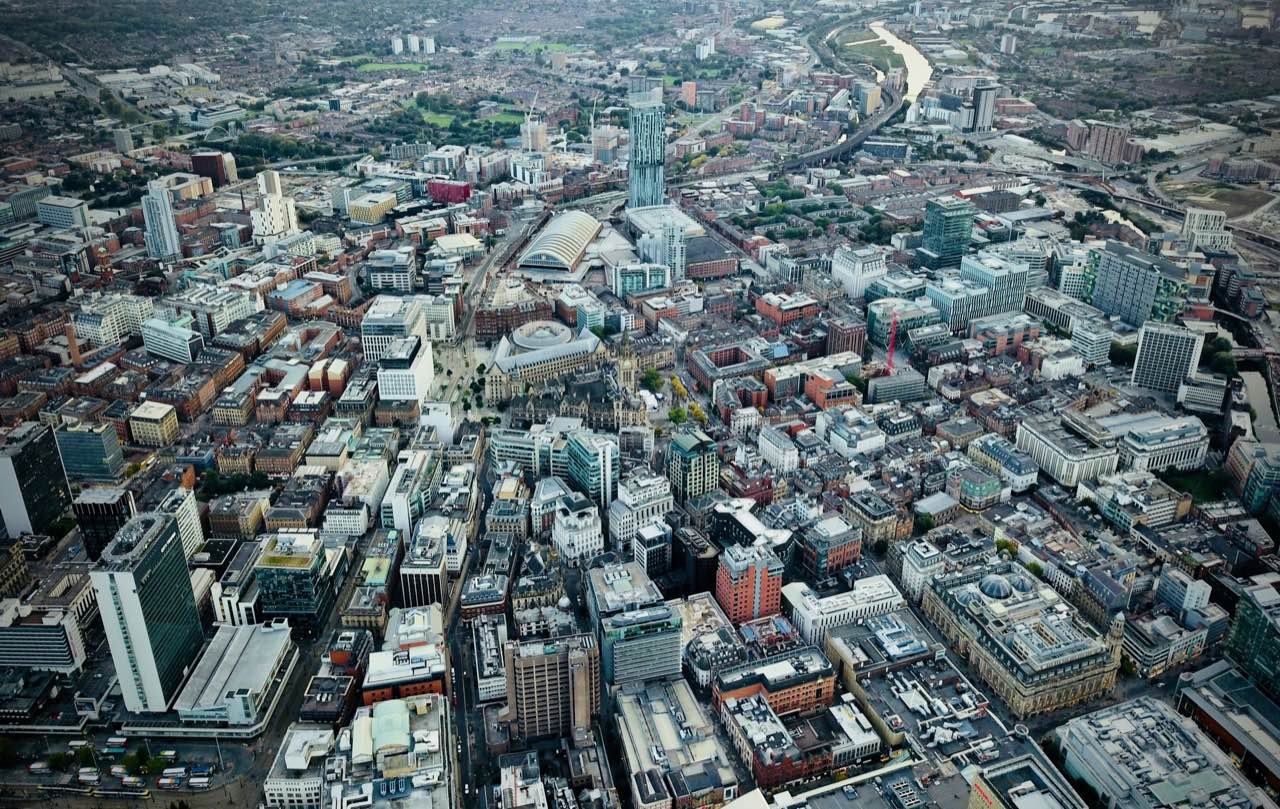 Aerial view over the rooftops and towers of Manchester city centre
